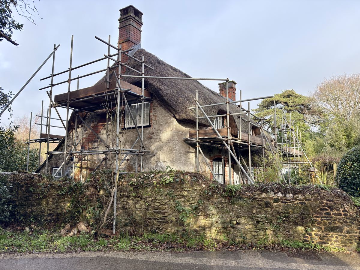 Domestic scaffolding on a thatched cottage for roof repairs, Isle of Wight