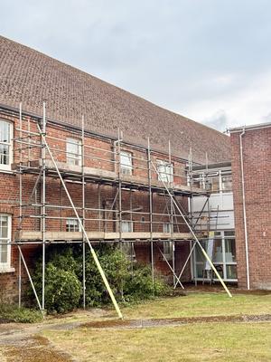 Red brick institutional building scaffolding
