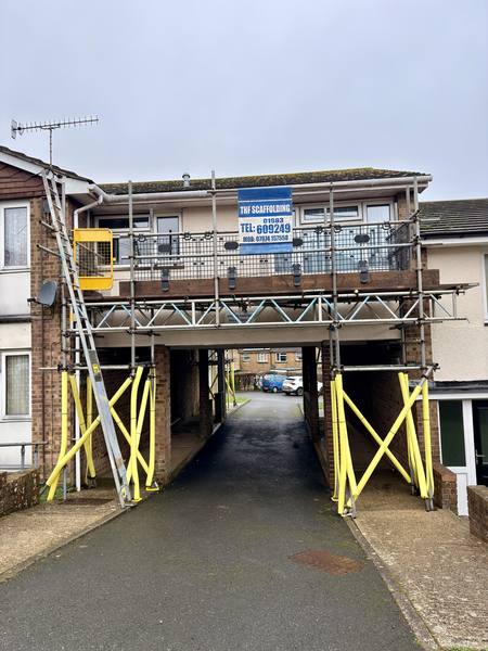 Residential block bridge scaffolding with THF banner