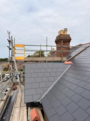 Rooftop scaffolding platform with new slate tiles