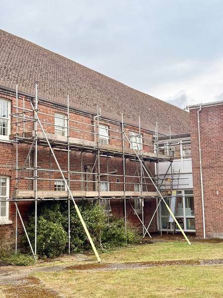 Red brick institutional building scaffolding